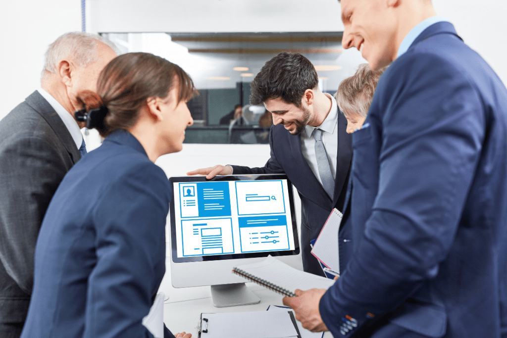 A group of business people looking at a computer screen.