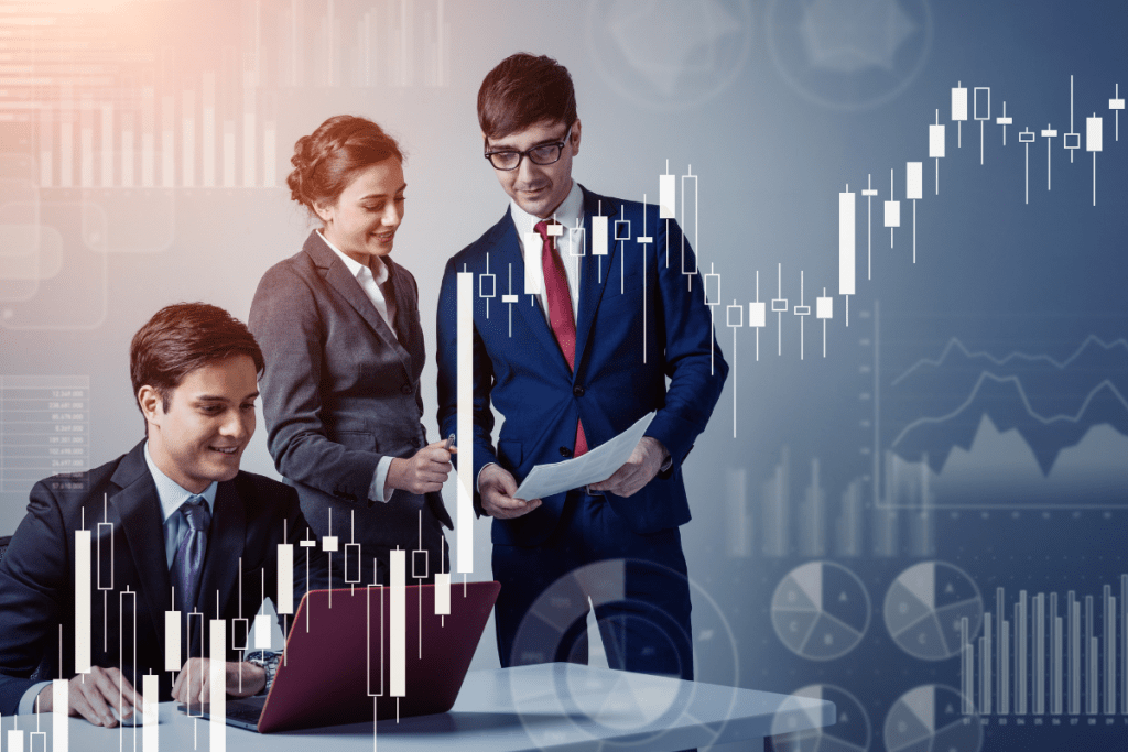 A group of business people looking at a stock chart.