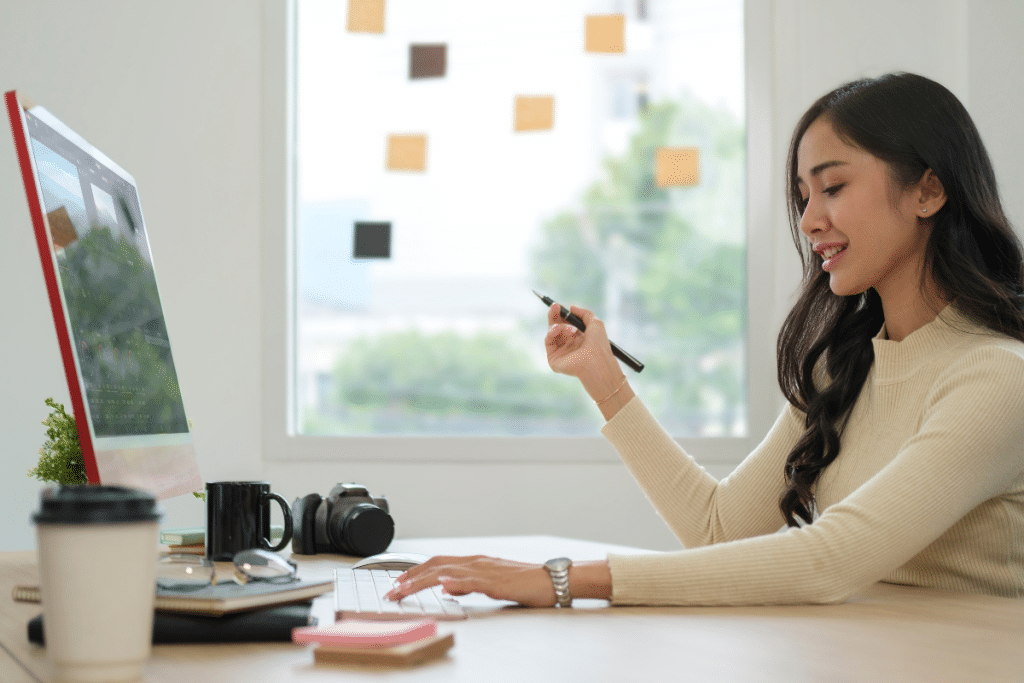 Asian woman working at her computer in the office.