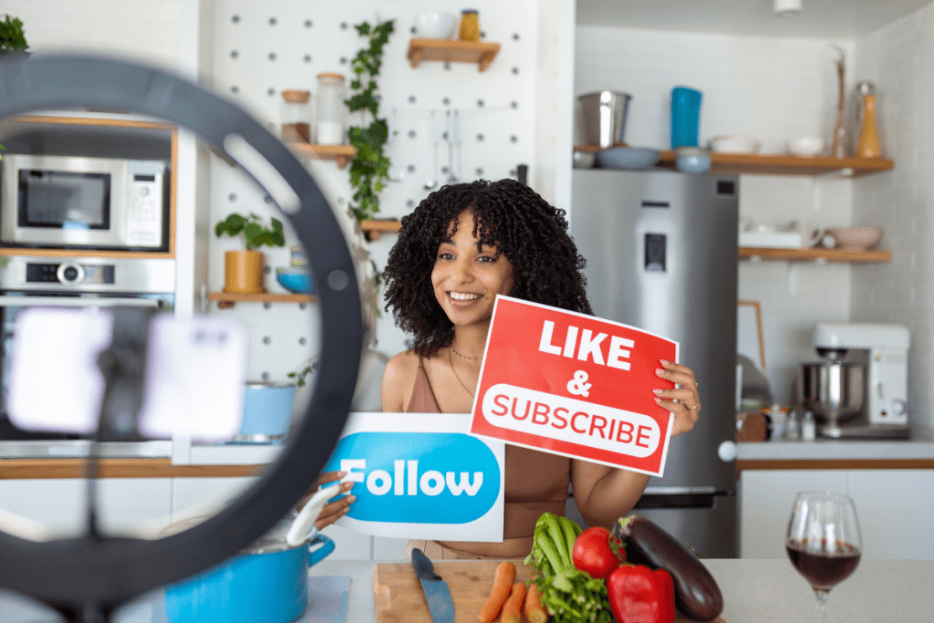 A woman holding up a sign that says like and subscribe.