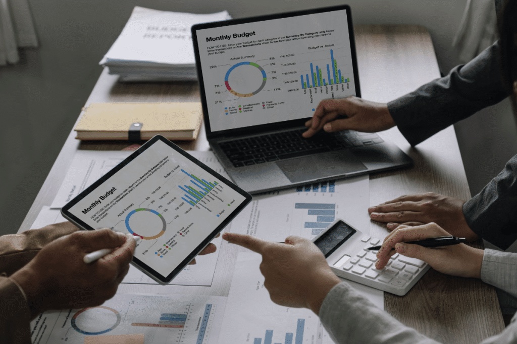 A group of people looking at graphs on a laptop.